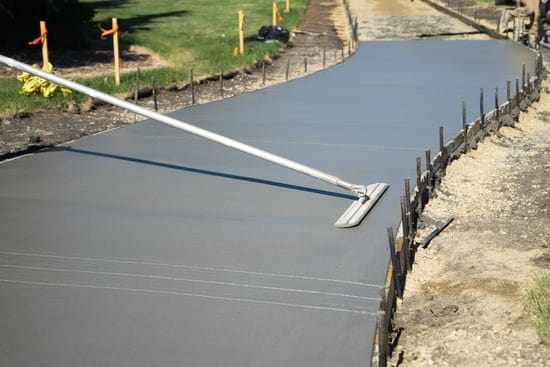 Large flattener smoothing out concrete paving.