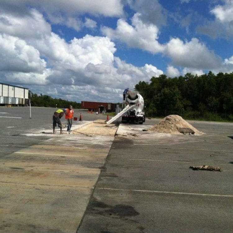 Skilled people working hard in asphalt paving.