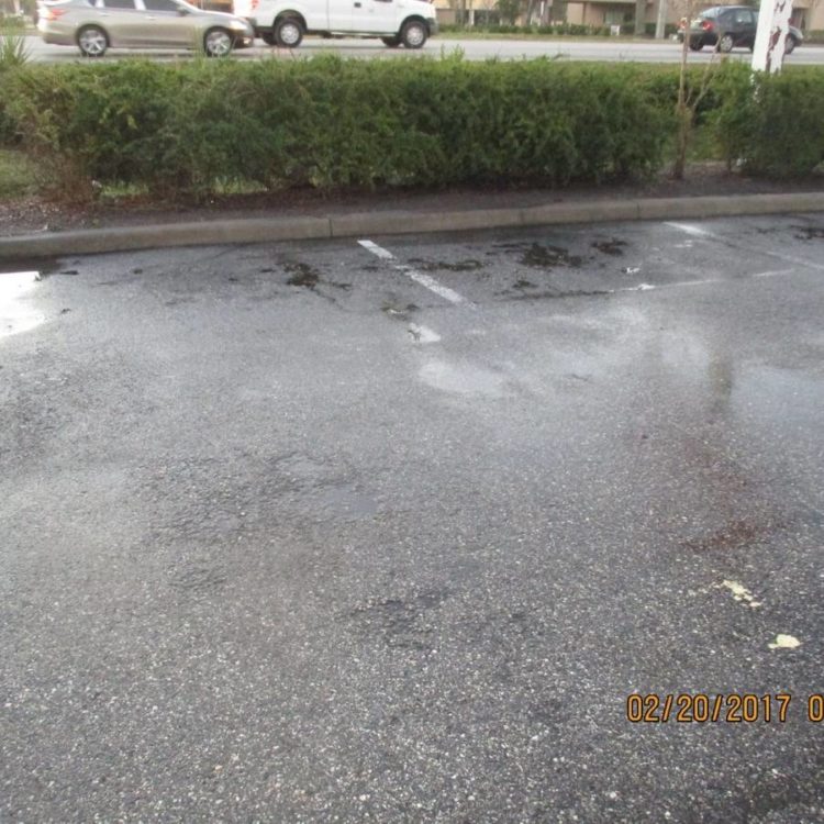 A parking lot that needs maintenance.
