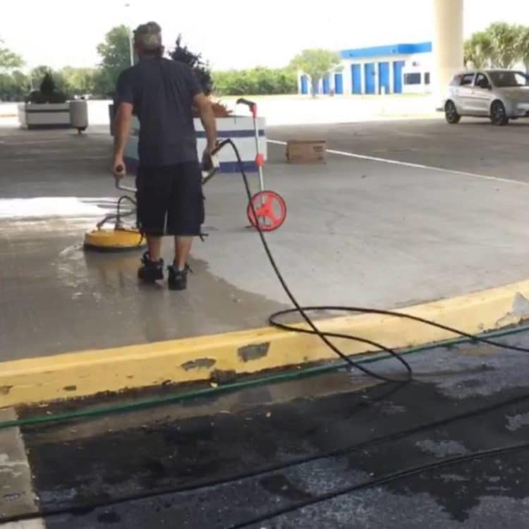 A mature guy cleaning the road before sealcoating.